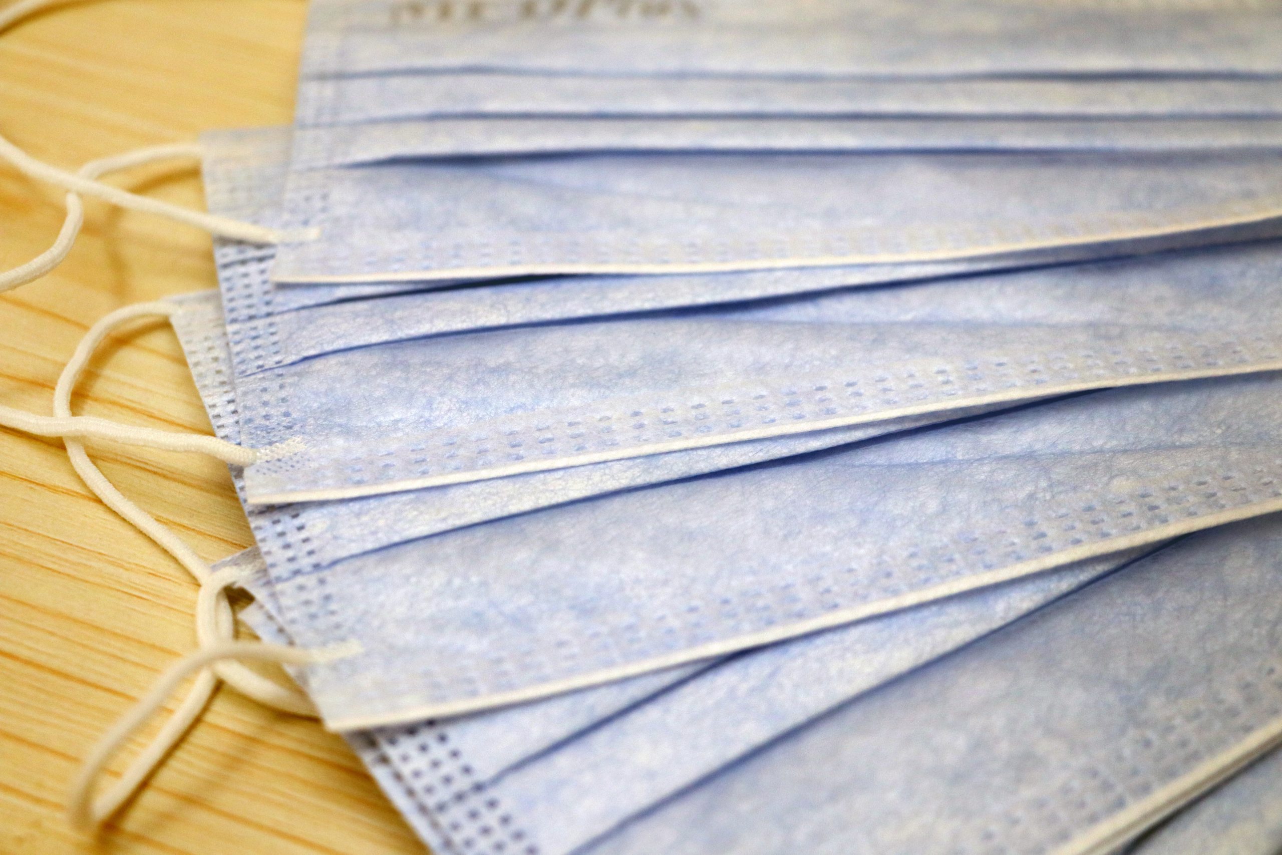 white and blue textile on brown wooden table